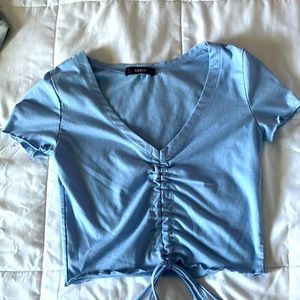 light blue crop top• cleavage